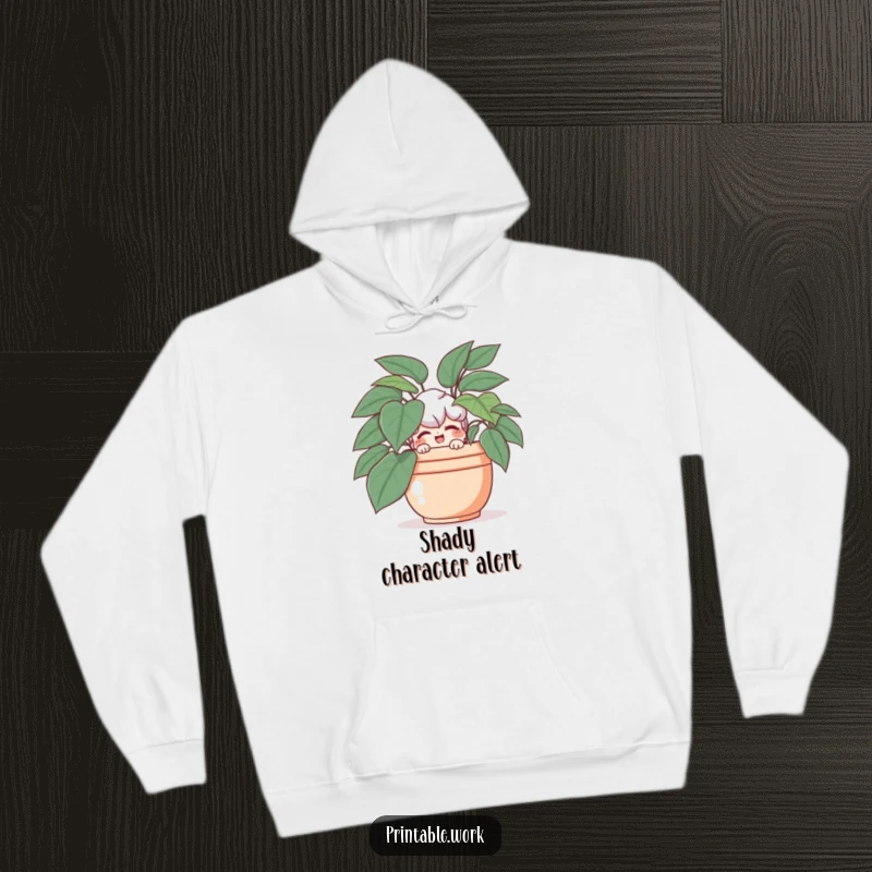 Funny hoodie displaying a playful character hiding behind a lush plant, giving a sly wink.