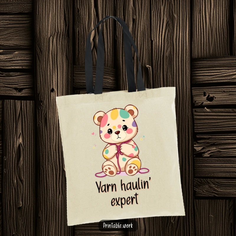Funny tote bag with a content bear character knitting a colorful abstract pattern, perfect for carrying craft supplies and daily items.